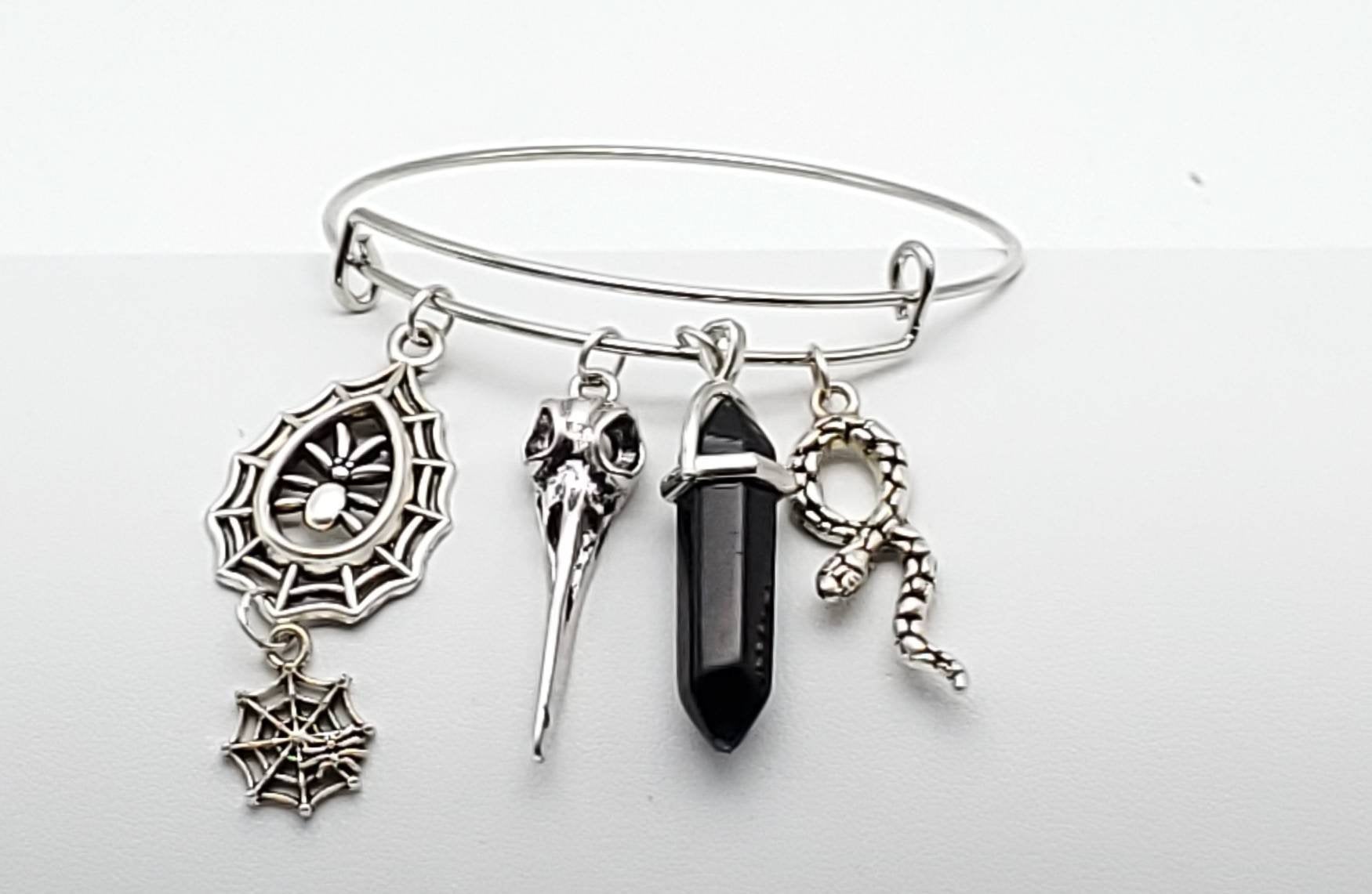 Charm Bangle with Spider Webs, Bird Skull and Snake Charms and Black Onyx Crystal - The Caffeinated Raven
